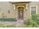 Stylish front entrance with stone accents and a charming arched doorway at 8946 Azalea Sands Ln # 8946, Davenport, FL 33896