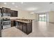 Modern kitchen with stainless steel appliances, dark cabinets and tile floors at 8946 Azalea Sands Ln # 8946, Davenport, FL 33896