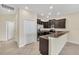 Modern kitchen with stainless steel appliances, dark cabinets and tile floors at 8946 Azalea Sands Ln # 8946, Davenport, FL 33896