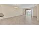 Bright living room featuring tile flooring, a modern chandelier, and sliding glass doors to a lanai at 8946 Azalea Sands Ln # 8946, Davenport, FL 33896