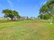 Well-maintained community green space with mature trees and lush, manicured lawns under a clear blue sky at 9000 Us Highway 192 # 896, Clermont, FL 34714