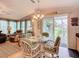 Bright dining area adjacent to the living room, featuring a chandelier and outdoor access at 9000 Us Highway 192 # 896, Clermont, FL 34714