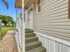 Side entrance view with stairs leading to the front door and striped awning at 9000 Us Highway 192 # 896, Clermont, FL 34714