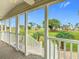 Picturesque view from the porch overlooking a beautifully landscaped green space with palm trees and vibrant scenery at 9000 Us Highway 192 # 896, Clermont, FL 34714