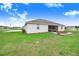 Home with a screened lanai with table set and a well-maintained lawn at 944 Lochland Loop, Bartow, FL 33830