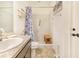 Bathroom featuring a tiled walk-in shower, vanity, and a blue patterned shower curtain at 944 Lochland Loop, Bartow, FL 33830