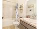 Bright bathroom with shower over tub, decorative shelves, and a marble effect sink countertop at 944 Lochland Loop, Bartow, FL 33830