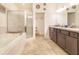 Elegant bathroom featuring a soaking tub, a glass-enclosed shower, and double vanity sinks at 944 Lochland Loop, Bartow, FL 33830