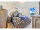 Bedroom showcasing a decorative bed frame, dresser, and a view of the sky through the window at 944 Lochland Loop, Bartow, FL 33830