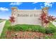 Estates at Sixty community entrance sign with stone pillars and lush landscaping at 944 Lochland Loop, Bartow, FL 33830