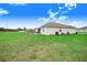 View of the home from an angle, showing the side yard and backyard at 944 Lochland Loop, Bartow, FL 33830