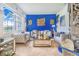 Bright living room featuring tufted sofa, chairs, gold accents, and decorative wall art at 944 Lochland Loop, Bartow, FL 33830