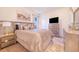 Beautiful main bedroom featuring a stylish bed, neutral decor, and a modern television set at 944 Lochland Loop, Bartow, FL 33830