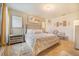 Calm main bedroom featuring a cushioned headboard, a sitting area, and neutral color scheme at 944 Lochland Loop, Bartow, FL 33830