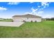 Exterior view of the side of the home, showcasing the garage and driveway at 944 Lochland Loop, Bartow, FL 33830