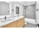 Modern bathroom featuring double vanity with quartz countertop and a large tiled shower-tub combo at 1020 Hobson St, Longwood, FL 32750