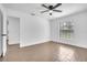 Light filled bedroom featuring wood-look tile, a ceiling fan, and a large window at 1020 Hobson St, Longwood, FL 32750