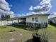Lush green backyard featuring a screened-in patio, providing an ideal space for outdoor enjoyment at 1042 Heirloom Dr, Haines City, FL 33844