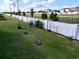 Backyard featuring a white fence and young trees at 1042 Heirloom Dr, Haines City, FL 33844