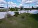 Large backyard featuring a pristine white fence, offering privacy and space for landscaping projects at 1042 Heirloom Dr, Haines City, FL 33844