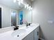 Bathroom featuring double sinks, a large mirror, and ample lighting at 1042 Heirloom Dr, Haines City, FL 33844