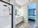 This bathroom features a glass-enclosed shower, a double vanity, and neutral tones at 1042 Heirloom Dr, Haines City, FL 33844