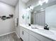 Modern bathroom with double sinks, sleek fixtures, and decorative fish accents on the wall at 1042 Heirloom Dr, Haines City, FL 33844