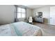 Bright bedroom features wood-look floors, neutral walls, and a stylish grey dresser and decor at 1042 Heirloom Dr, Haines City, FL 33844