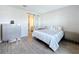 Relaxing bedroom showcases wood-look floors, sliding door to bathroom, and a grey dresser at 1042 Heirloom Dr, Haines City, FL 33844