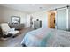 Relaxing bedroom with neutral walls, sliding door, grey dresser, and a comfy-looking chair at 1042 Heirloom Dr, Haines City, FL 33844
