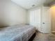 Neutral bedroom featuring a closet, carpet, and a bed with patterned bedding at 1042 Heirloom Dr, Haines City, FL 33844