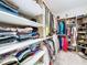 Well-organized walk-in closet with built-in shelving and ample storage space for clothes and shoes at 1042 Heirloom Dr, Haines City, FL 33844