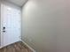 Clean entryway featuring a white door, wood-look floors, and neutral wall paint at 1042 Heirloom Dr, Haines City, FL 33844