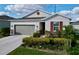 Charming single-Gathering home with manicured landscaping, stone accents, and a two-car garage at 1042 Heirloom Dr, Haines City, FL 33844