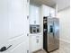 Modern kitchen features stainless steel refrigerator, microwave and white cabinetry at 1042 Heirloom Dr, Haines City, FL 33844