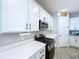 The kitchen area offers white cabinets and quartz countertops, paired with stainless steel appliances at 1042 Heirloom Dr, Haines City, FL 33844