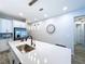 Bright kitchen with a large island, stainless steel refrigerator, and pendant lighting at 1042 Heirloom Dr, Haines City, FL 33844