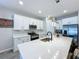 Modern kitchen features a large island, stainless steel appliances, and white cabinetry at 1042 Heirloom Dr, Haines City, FL 33844