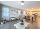 Open concept living area features tile flooring and seamless transition to kitchen and dining spaces at 1042 Heirloom Dr, Haines City, FL 33844