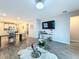 Open concept living area features tile flooring and seamless transition to kitchen and dining spaces at 1042 Heirloom Dr, Haines City, FL 33844