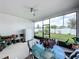 Screened-in patio with dining set and refrigerator, providing a comfortable and functional outdoor living space at 1042 Heirloom Dr, Haines City, FL 33844