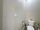 Neutral-toned toilet room with classic toilet, roll holder, and neutral paint at 1042 Heirloom Dr, Haines City, FL 33844