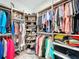 Organized walk-in closet featuring ample hanging space and rotating shoe shelves for optimal storage and accessibility at 1042 Heirloom Dr, Haines City, FL 33844