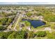 Aerial view showcasing a community, featuring serene lake views and neatly arranged residential properties at 1062 Hidden Dr, Lakeland, FL 33809