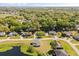 Idyllic aerial view featuring a home near a lake, surrounded by trees and other well-maintained residences at 1062 Hidden Dr, Lakeland, FL 33809