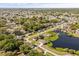 Beautiful aerial view showcasing homes with lake access and lush landscaping, offering a tranquil residential setting at 1062 Hidden Dr, Lakeland, FL 33809