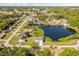 Nice aerial view featuring houses near a lake, highlighting lovely scenery and nearby trees for curb appeal at 1062 Hidden Dr, Lakeland, FL 33809
