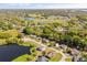 Charming aerial view featuring properties situated alongside a serene lake, highlighting attractive landscape design at 1062 Hidden Dr, Lakeland, FL 33809