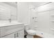 Bright bathroom features a white vanity, toilet, and walk-in shower at 1062 Hidden Dr, Lakeland, FL 33809
