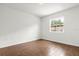 Empty bedroom with wood tile flooring, natural light, and neutral paint at 1062 Hidden Dr, Lakeland, FL 33809